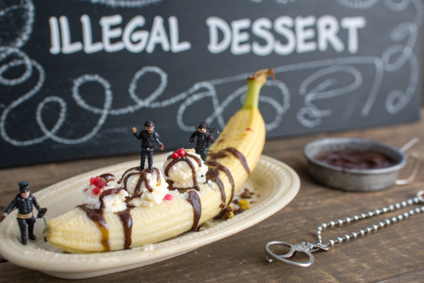 A humorous depiction of a banana split being 'arrested.'